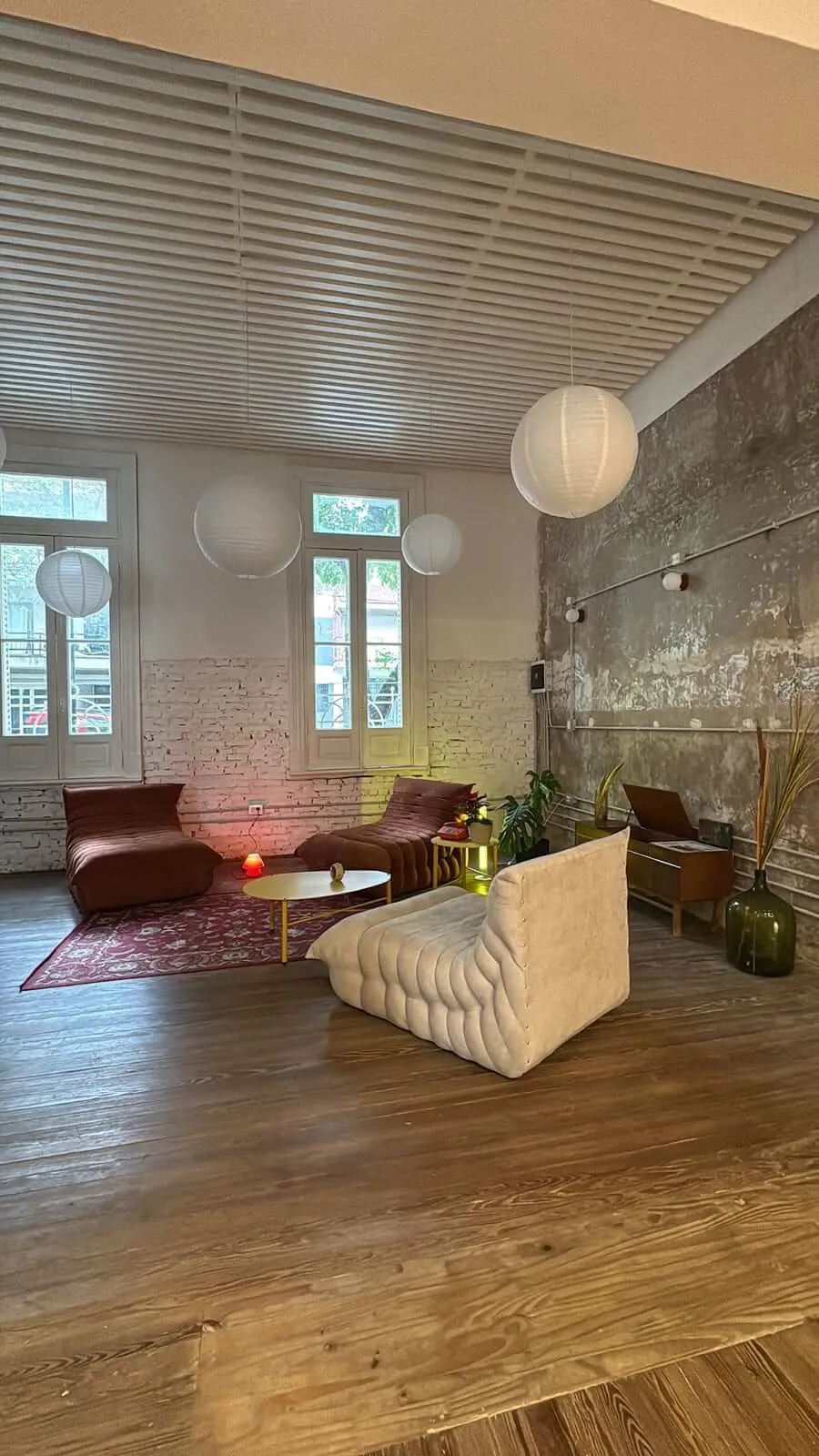 El rincón de estar de La Casa, con sillones, alfombra y farolillos de papel